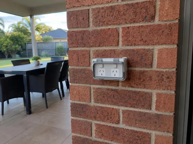 Weatherproof double power point on a brick patio column beside an outdoor dining area in Helensvale